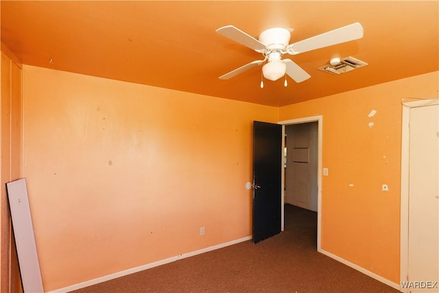 unfurnished room featuring baseboards, carpet, visible vents, and a ceiling fan