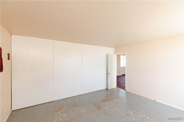 unfurnished room featuring concrete flooring