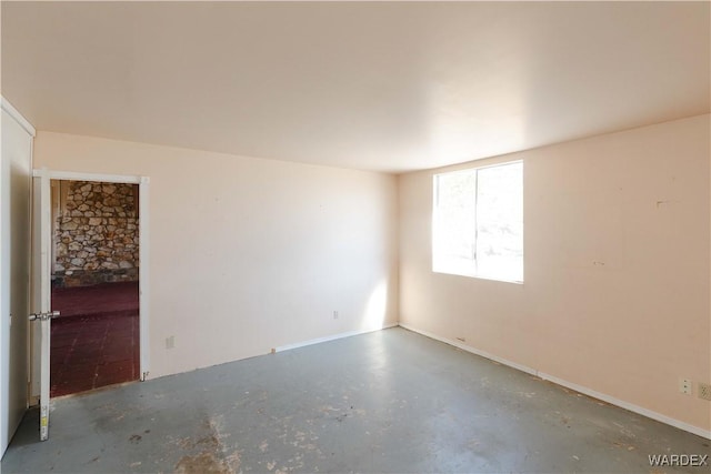 unfurnished room featuring concrete floors