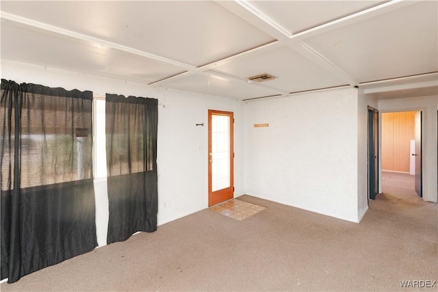 unfurnished room with carpet and visible vents