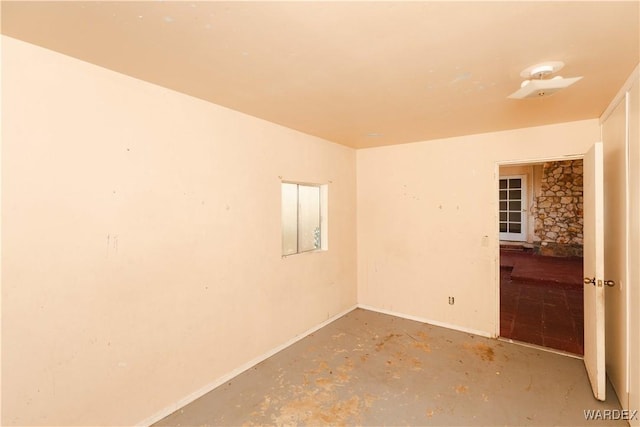 spare room with unfinished concrete flooring