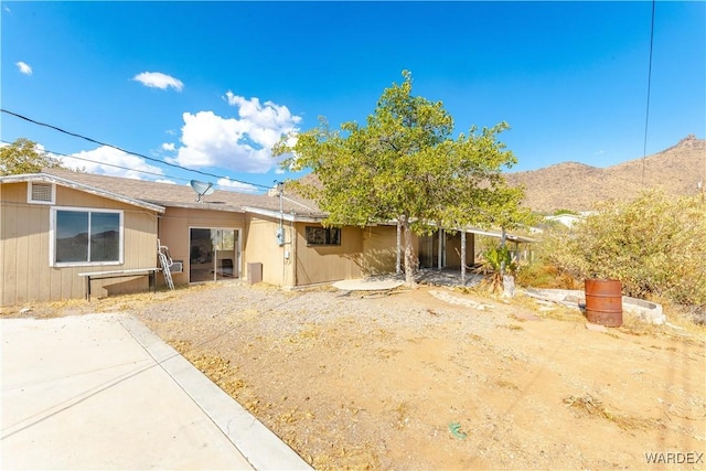 rear view of property with a patio area and a mountain view