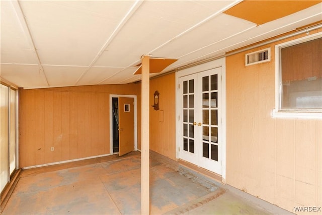 view of exterior entry with a patio, french doors, and visible vents