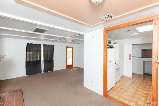 empty room with light carpet, light floors, and visible vents