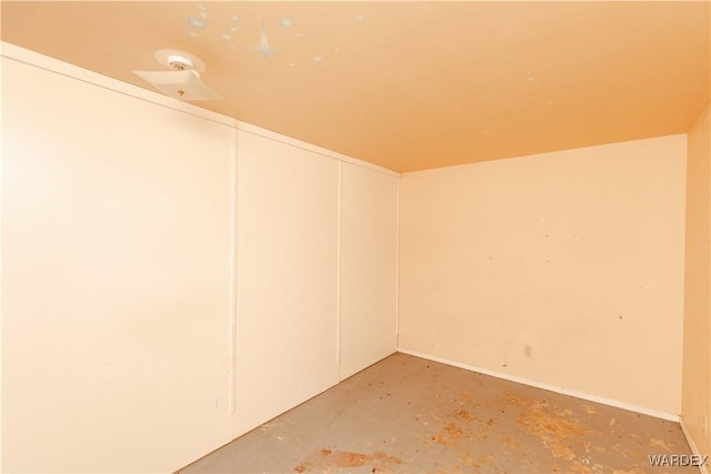 empty room with concrete flooring