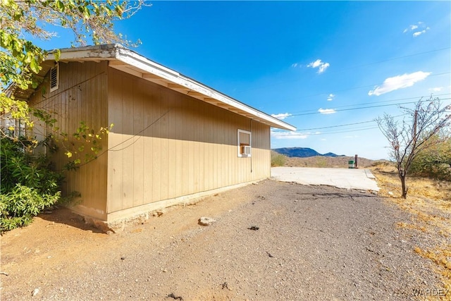 view of home's exterior featuring cooling unit and a mountain view