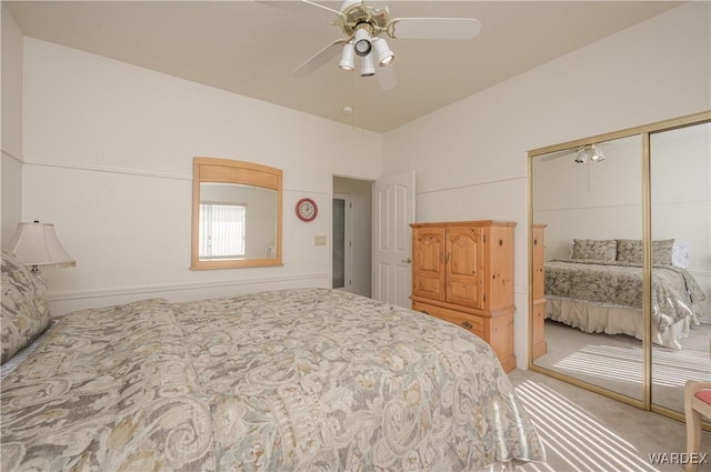 carpeted bedroom with a ceiling fan and a closet