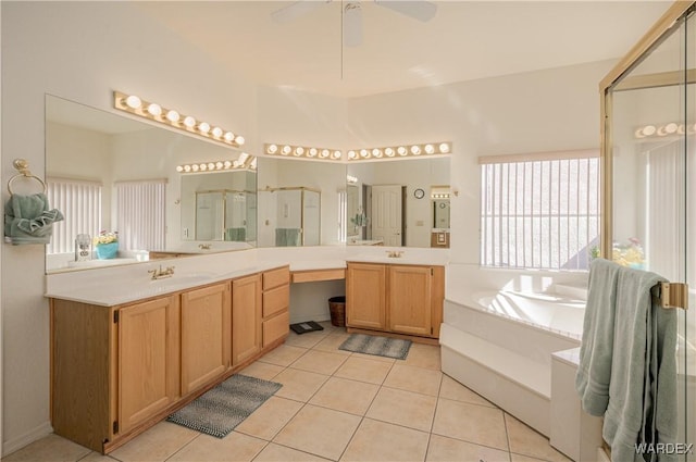 bathroom featuring tile patterned floors, a ceiling fan, a stall shower, vanity, and a bath