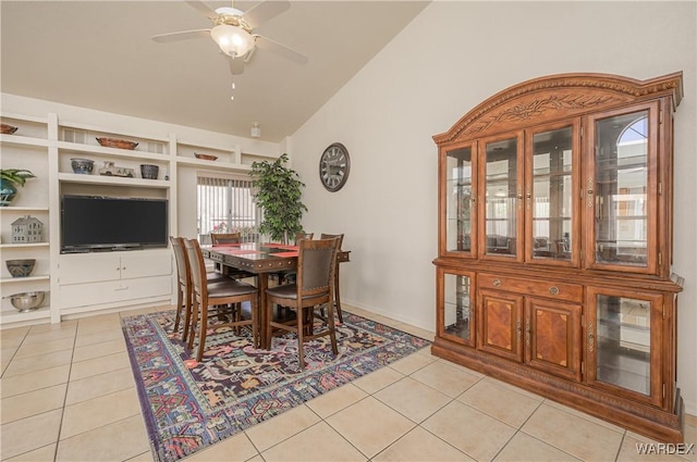 dining space featuring light tile patterned floors, lofted ceiling, and a ceiling fan