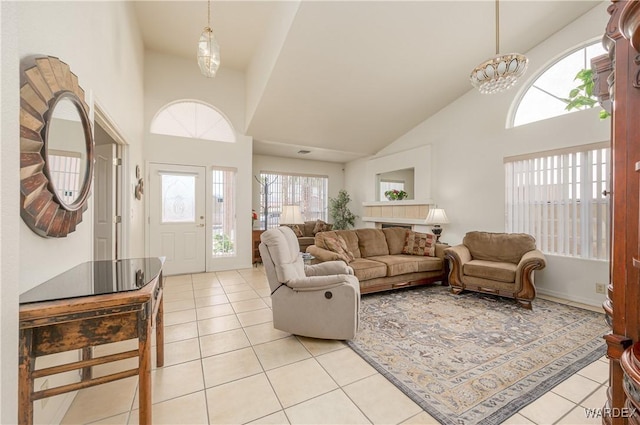 living room with a high ceiling and light tile patterned flooring