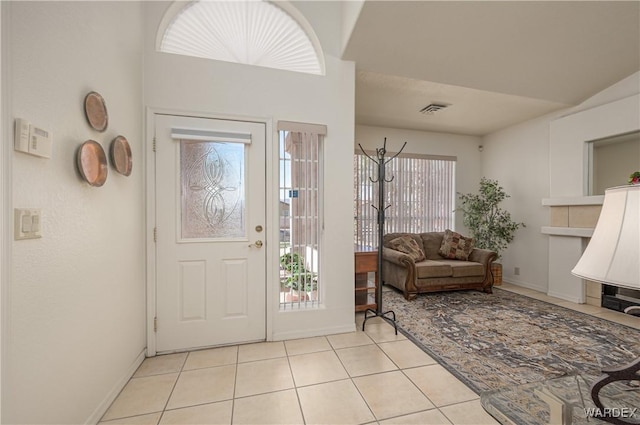 foyer entrance with light tile patterned floors, visible vents, and baseboards