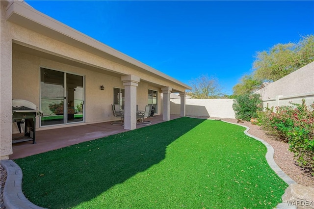 view of yard featuring a patio area and a fenced backyard