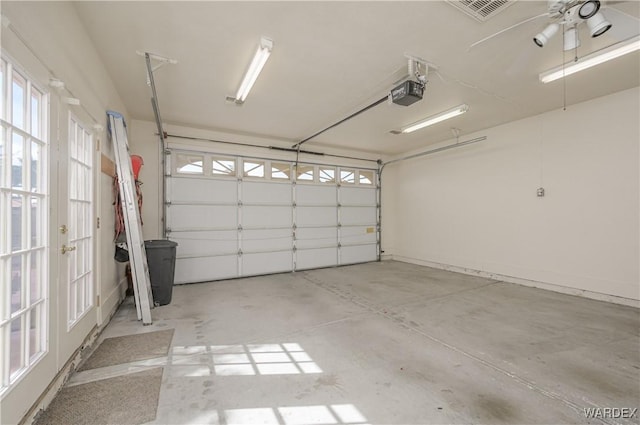 garage with visible vents and a garage door opener