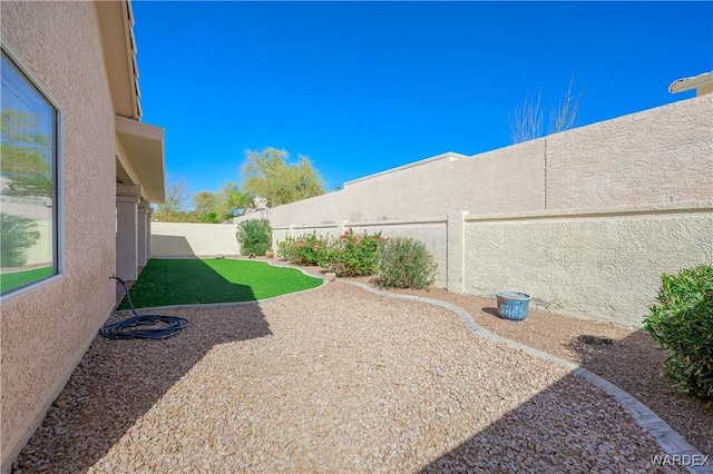 view of yard with a fenced backyard