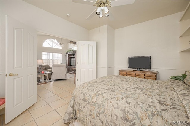 bedroom with a ceiling fan and light tile patterned flooring