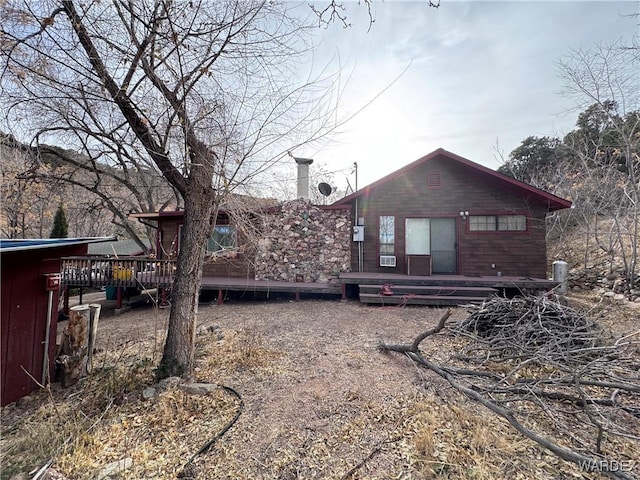 back of property with a wooden deck