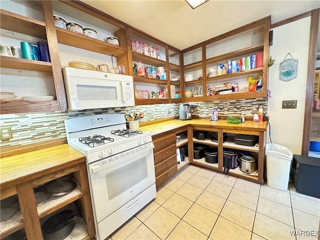 kitchen with butcher block counters, white appliances, tasteful backsplash, and light tile patterned floors