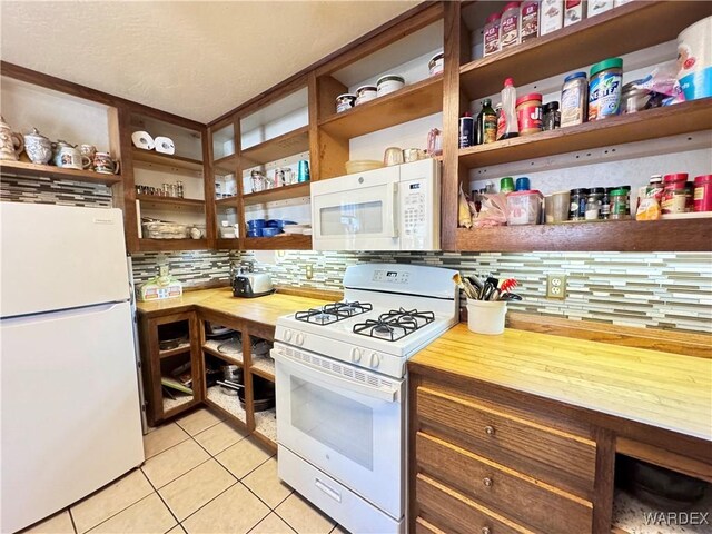 kitchen featuring white appliances, light tile patterned floors, decorative backsplash, light countertops, and open shelves