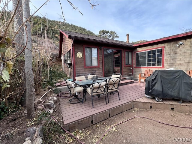 deck with outdoor dining area and area for grilling