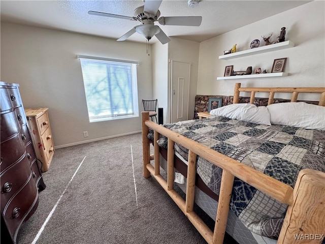 carpeted bedroom with a ceiling fan, a textured ceiling, and baseboards