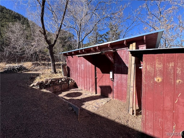 view of home's exterior with an outbuilding