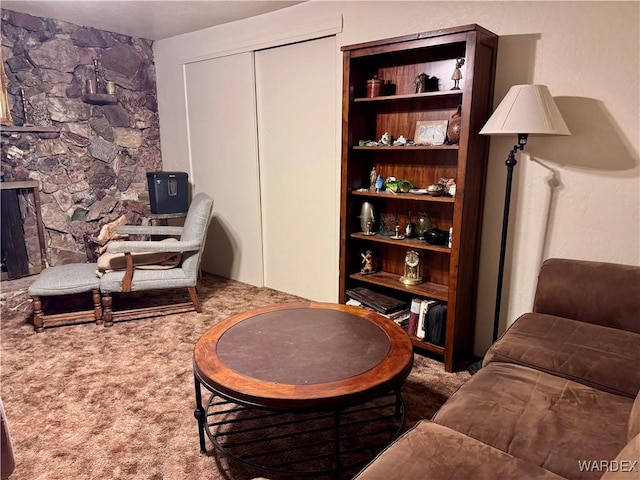 living area with carpet and a fireplace