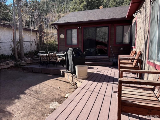 wooden terrace featuring entry steps, outdoor lounge area, a grill, and fence