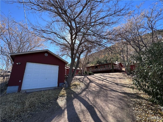 detached garage featuring driveway and a mountain view