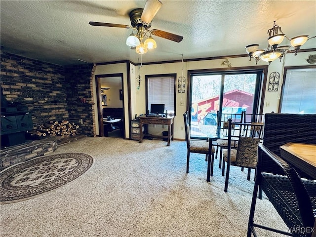 dining space with carpet flooring, a textured ceiling, brick wall, and ceiling fan with notable chandelier