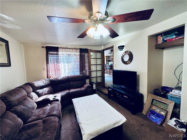 living room with a textured wall, dark carpet, a textured ceiling, and ceiling fan