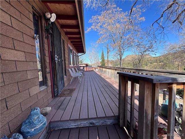 wooden terrace featuring a mountain view