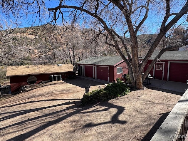 view of front of house with driveway and brick siding