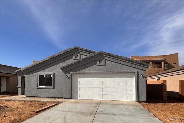 ranch-style home with a garage, driveway, and stucco siding