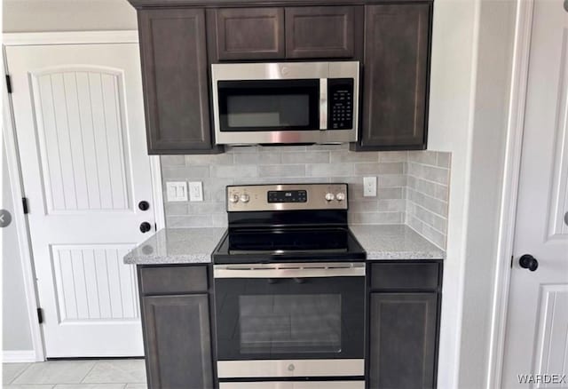 kitchen featuring dark brown cabinets and appliances with stainless steel finishes