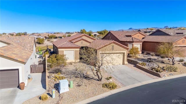 view of front of property featuring a residential view, driveway, an attached garage, and stucco siding