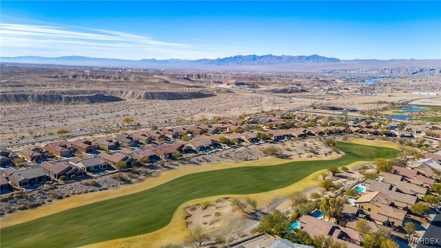 drone / aerial view featuring view of golf course, a water and mountain view, and a residential view