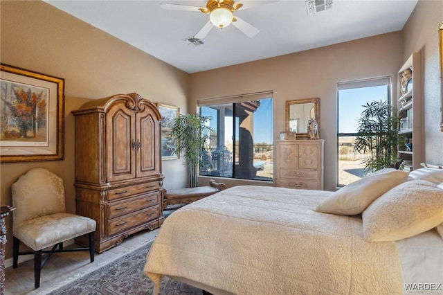 bedroom featuring a ceiling fan, access to outside, and visible vents