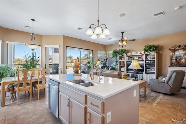 kitchen featuring visible vents, an island with sink, open floor plan, pendant lighting, and a sink