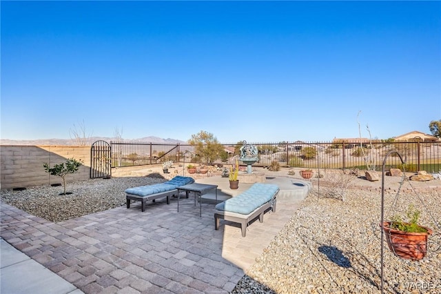 view of patio / terrace with a fenced backyard and a gate