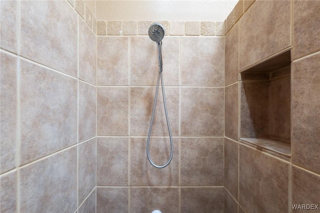 interior details with a tile shower