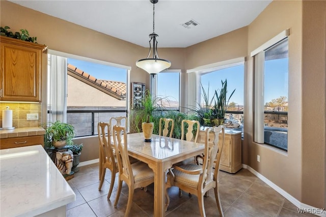 dining room with baseboards, visible vents, a wealth of natural light, and light tile patterned flooring