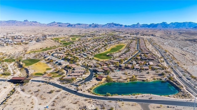 drone / aerial view featuring golf course view and a water and mountain view