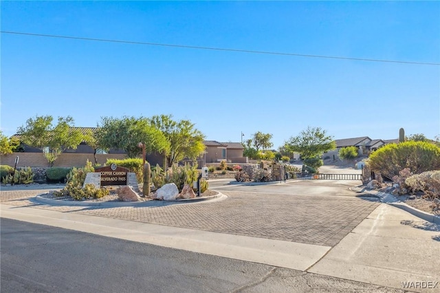 view of front of home featuring a residential view and a gate