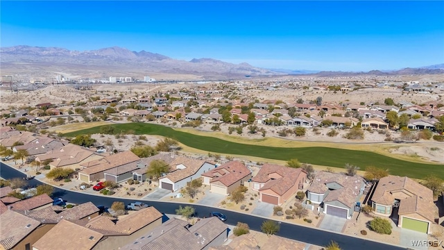 drone / aerial view with a residential view, a mountain view, and golf course view