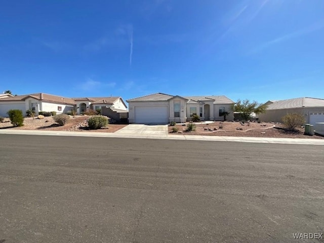 view of front of house featuring a garage, a residential view, and concrete driveway