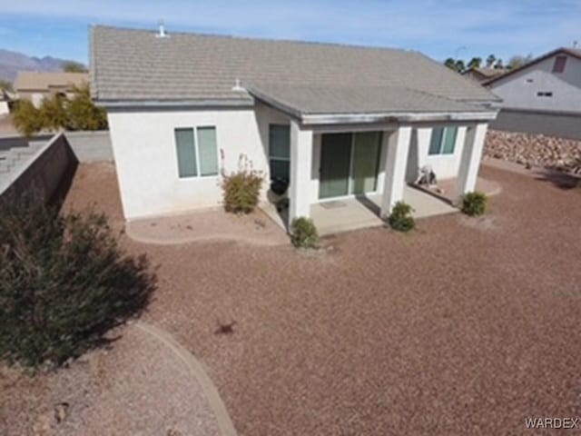 back of property with a patio