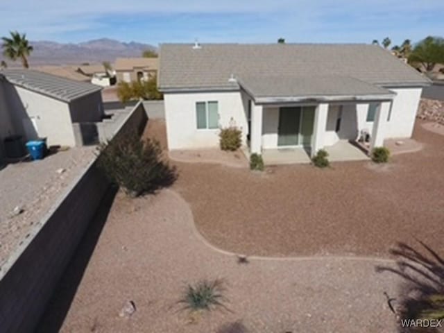 rear view of house featuring a mountain view and a patio