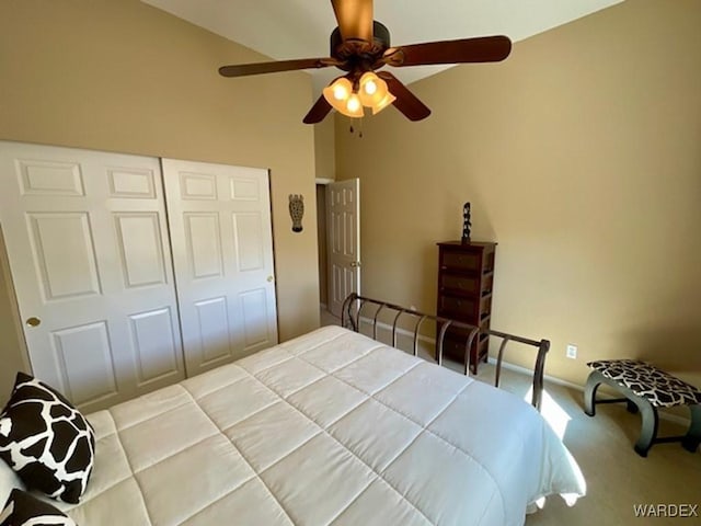 bedroom with carpet floors, lofted ceiling, a closet, ceiling fan, and baseboards