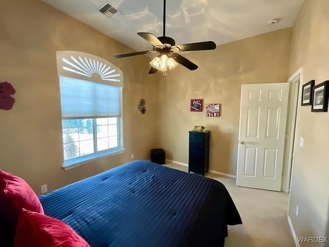 bedroom with light carpet, baseboards, visible vents, and a ceiling fan