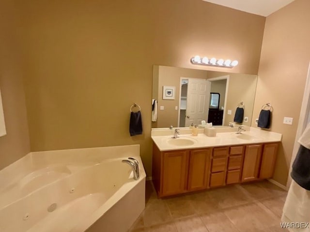 bathroom with double vanity, a whirlpool tub, a sink, and tile patterned floors